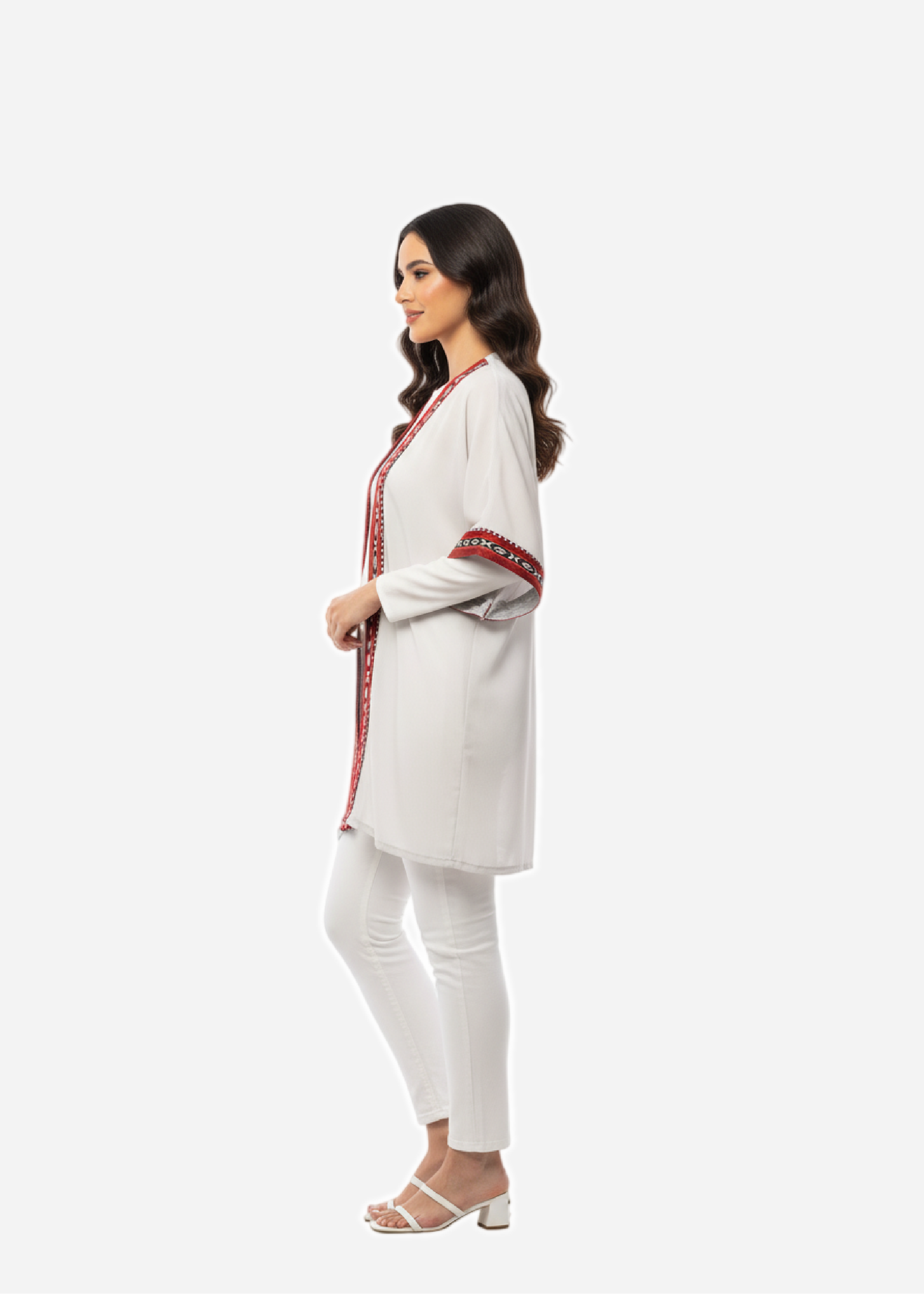Woman wearing a white outfit with red accents on a white background