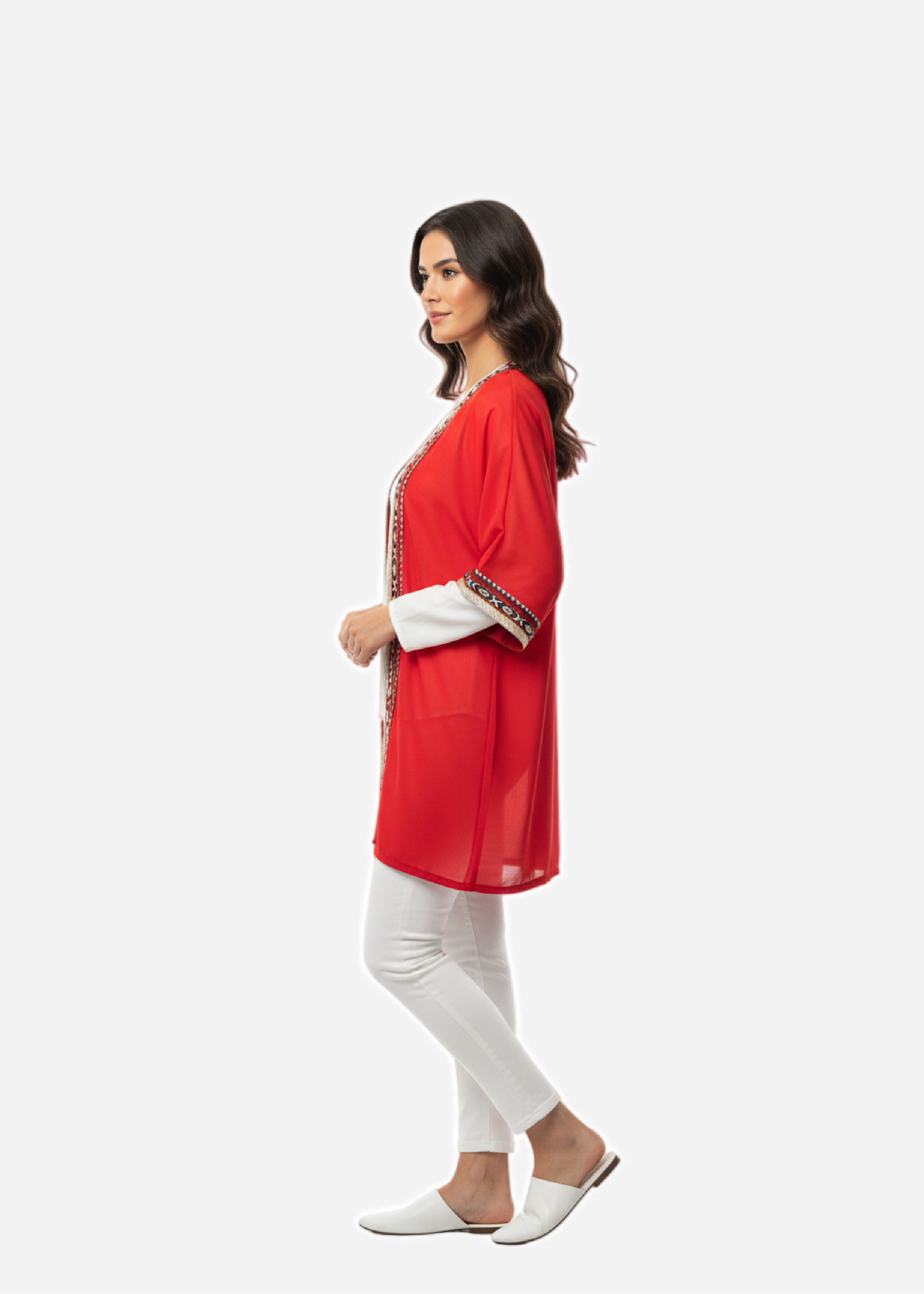 Woman wearing a red outfit with white pants on a white background