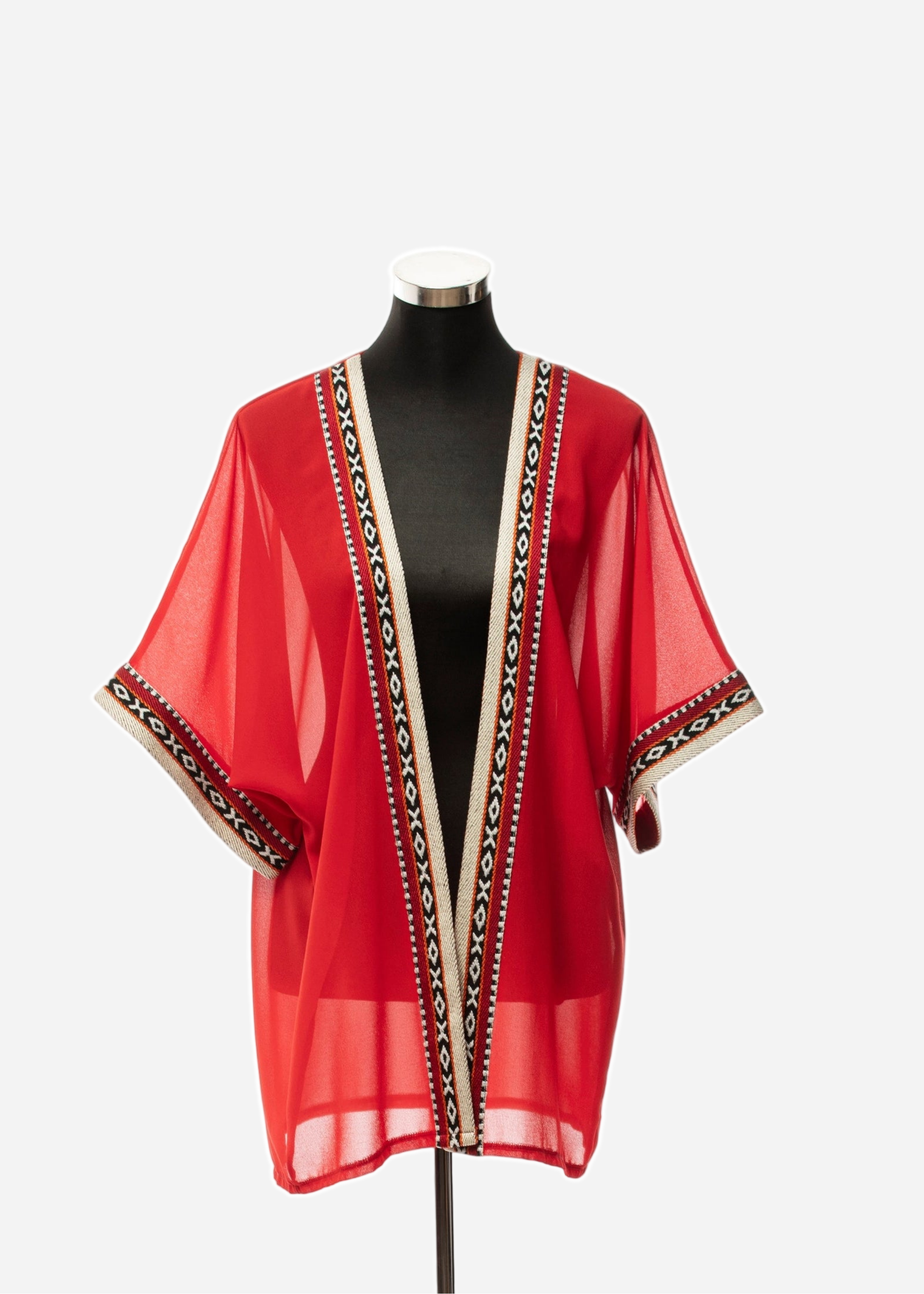 Red sheer top with black and white pattern on a mannequin against a white background