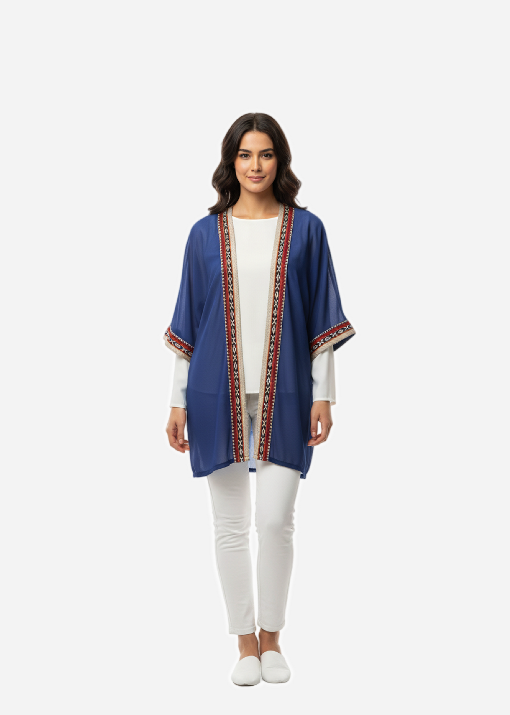 Woman wearing a blue kimono-style jacket with a white top and pants on a white background