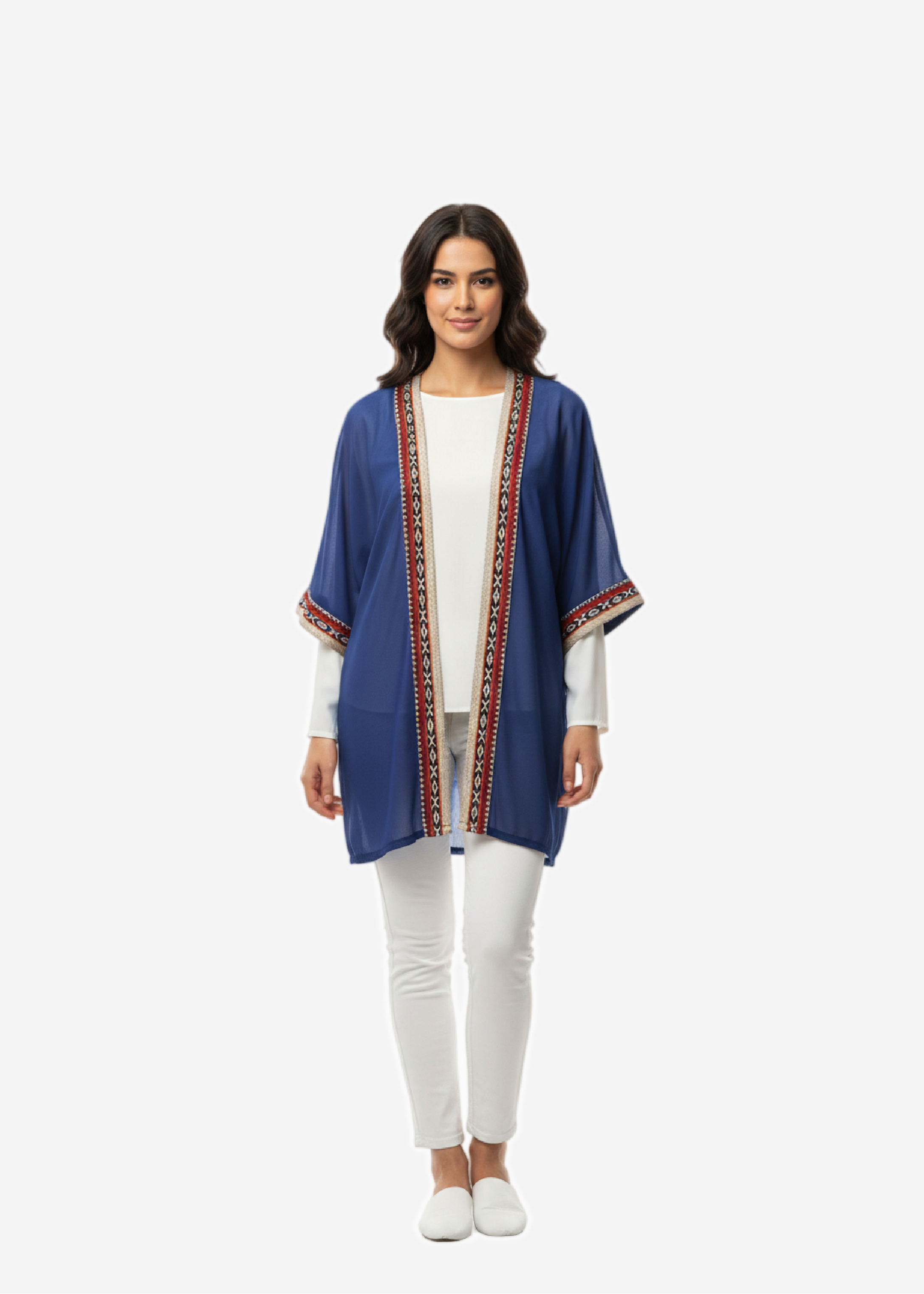 Woman wearing a blue kimono-style jacket with a white top and pants on a white background