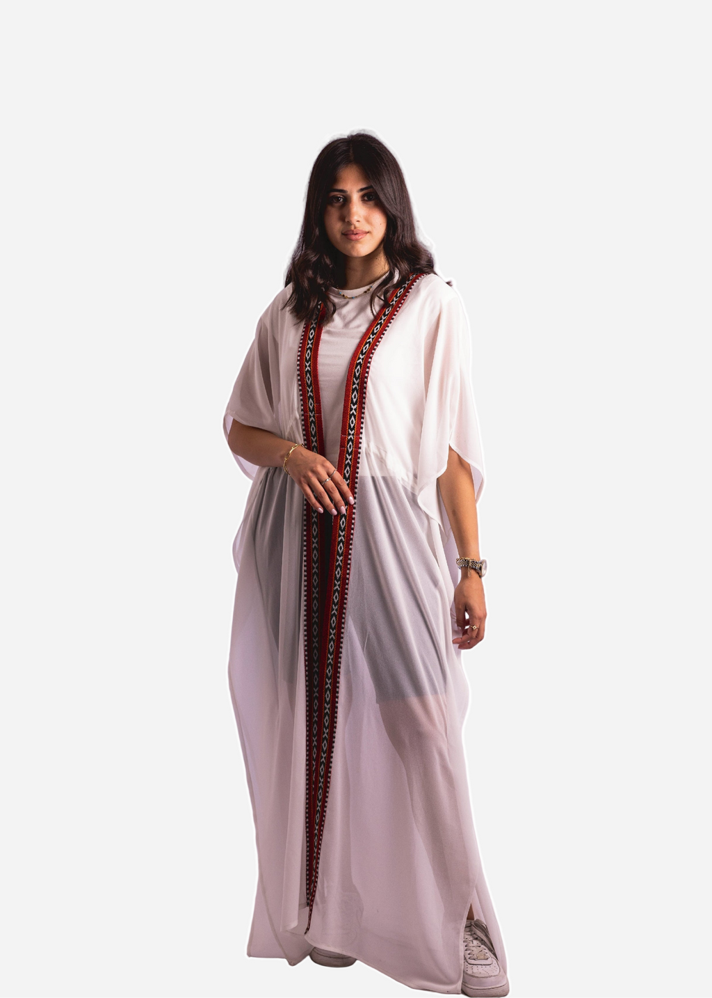 Woman wearing a white dress with red embroidery on a white background