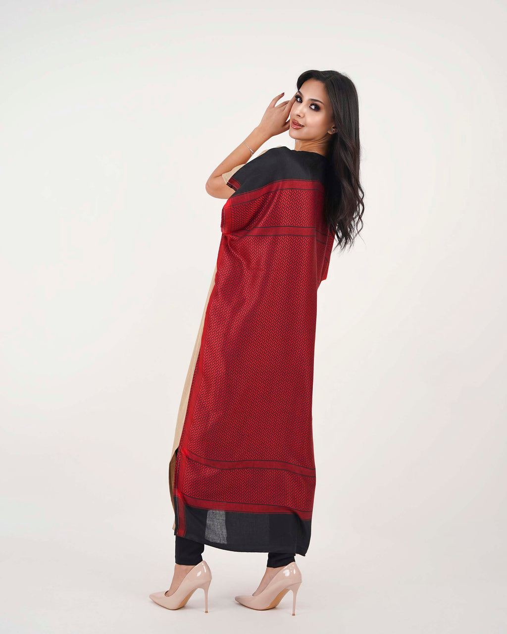 Woman wearing a red and black dress on a white background